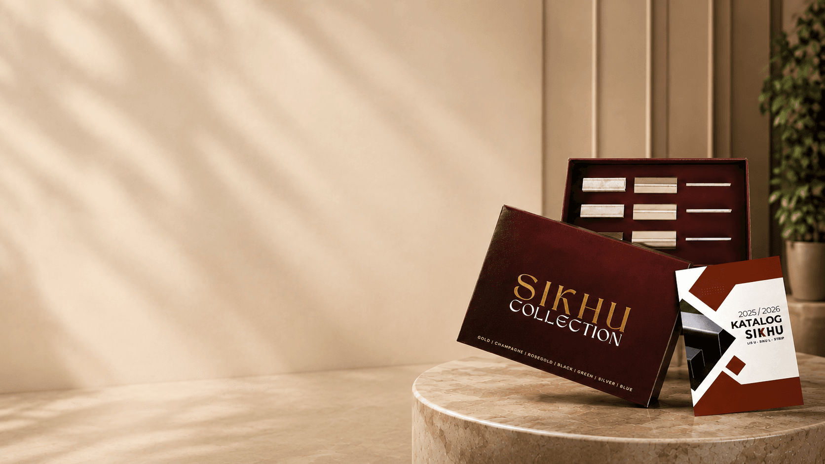 SIKHU Collection Sample Box holding stainless trim offcuts in seven colors, with the 2025/2026 catalog book, on a marble table